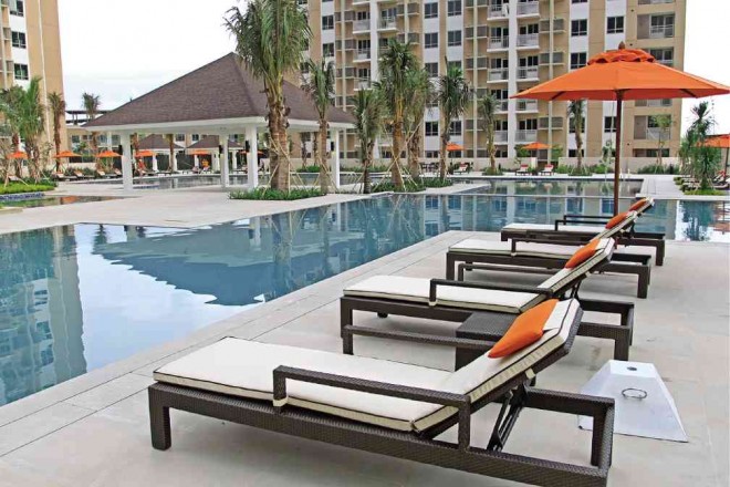 AT THE Amenity Deck, residents can swim laps or read a book on one of the many lounge chairs lining the pools.