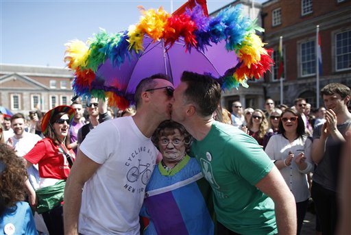 Two men kiss as first results start to filter through in the referendum, Dublin, Ireland, Saturday, May 23, 2015. Ireland has voted resoundingly to legalize gay marriage in the world's first national vote on the issue, leaders on both sides of the Irish referendum declared Saturday even as official ballot counting continued. AP 