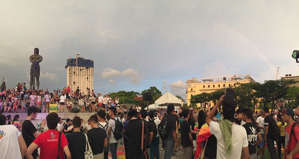 After a brief rain, a rainbow shines over a crowd of lesbian, gay, bisexual and transgender (LGBT) who congregated before the Lapu Lapu statue in Rizal Park for this year's Metro Manila Pride March. Photo by Marc Jayson Cayabyab