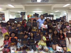 ARTIST Wilfredo Offemaria Jr. with workshop participants proudly showing their creations