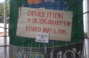 DEMOLITION permit posted at the compound's gate