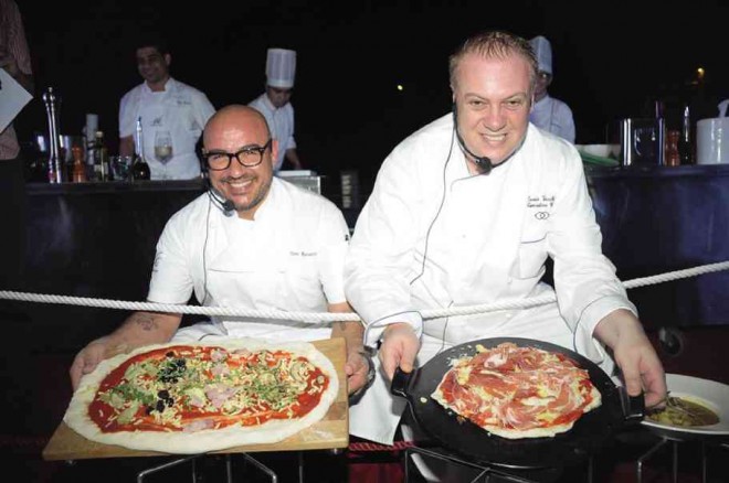 CHEF FACE-OFF: Chef Toni Rossetti of Noti, who hails from Puglia in southern Italy, with his “pizza al metro”; and Chef Denis Vecchiato of Sofitel, from Veneto in the north, with his pizza prosciutto