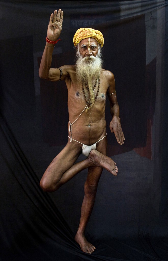 In this Friday, June 12, 2015 photo, Sita Ram Baba, an Indian Hindu holy man, displays the yoga pose Vriksasana or Tree pose in Gauhati, India. Sunday marks the first International Yoga Day, which the government of India Prime Minister Narendra Modi is marking with a massive outdoor New Delhi gathering. (AP Photo/Anupam Nath)