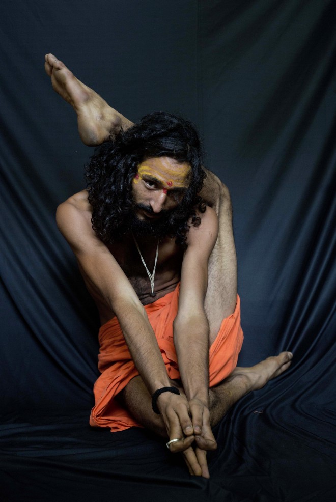 In this Friday, June 12, 2015 photo, Bhrahaspati Bharti Baba, an Indian Hindu holy man, demonstrates the yoga pose Eka Pada Sirsasana, where his foot is behind his head, in Gauhati, India. Sunday marks the first International Yoga Day, which the government of India Prime Minister Narendra Modi is marking with a massive outdoor New Delhi gathering. (AP Photo/Anupam Nath)