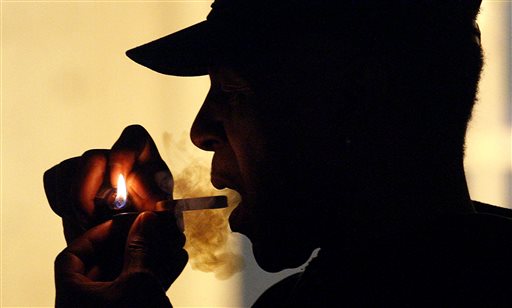 In this May 5, 2011, file photo an unidentified man smokes medical marijuana during karaoke night at the Cannabis Cafe, in Portland, Oregon. AP 