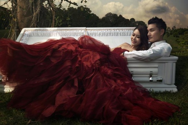 Their lives are inextricably linked to their profession so Jenny Tay and Darren Cheng decided on wedding photos featuring a casket as a prop. PHOTO: JENNY TAY/STRAITSTIMES