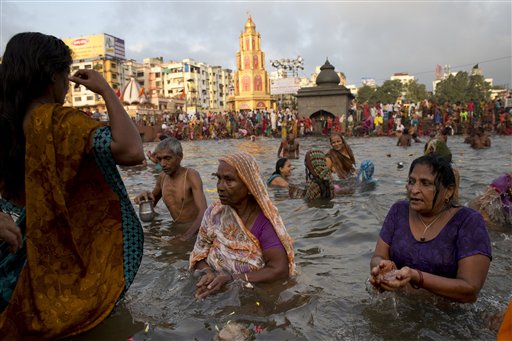 Indian devotees perform rituals as they take holy dips in the Godavari River during Kumbh Mela, or Pitcher Festival, in Nasik, India, Wednesday, Aug. 26, 2015. AP