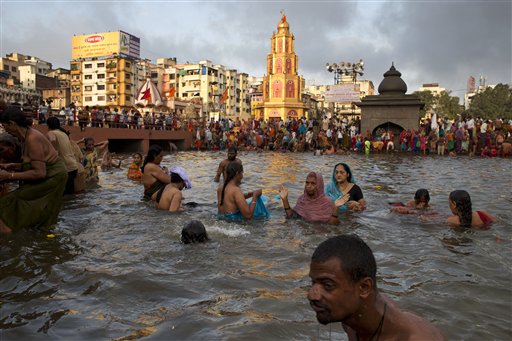 Indian pilgrims take holy dips in the Godavari River during Kumbh Mela, or Pitcher Festival, in Nasik, India, Wednesday, Aug. 26, 2015. AP