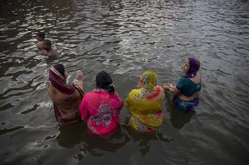 Indian women pilgrims perform rituals in the Godavari River during Kumbh Mela, or Pitcher Festival, in Nasik, India, Wednesday, Aug. 26, 2015. AP