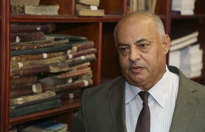 In this Tuesday, July 28, 2015 photo, Jamal Abdel-Majeed Abdulkareem, acting director of Baghdad libraries and archives, speaks during an interview with The Associated Press at the Baghdad National Library in Iraq. AP