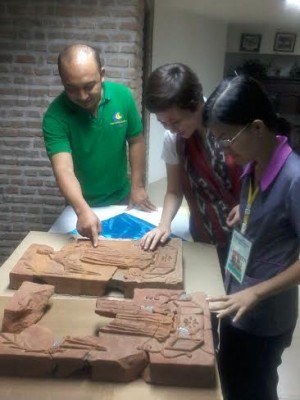 MUNICIPAL employees check two of the unearthed bricks with relief.