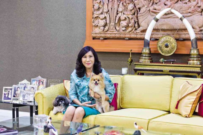 Monthip “Bee” Upatising with her pets Kuichai and McQueen, given by Thai royals.