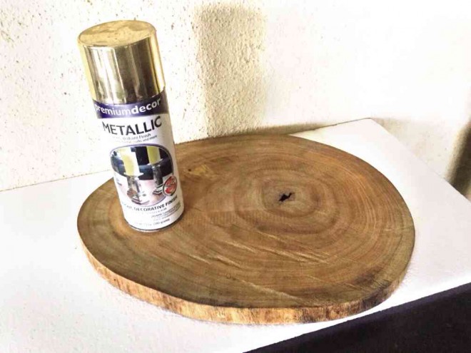 SPRAYmetallic silver enamel paint on piece of tree trunk or wooden chopping board to make it look elegant.