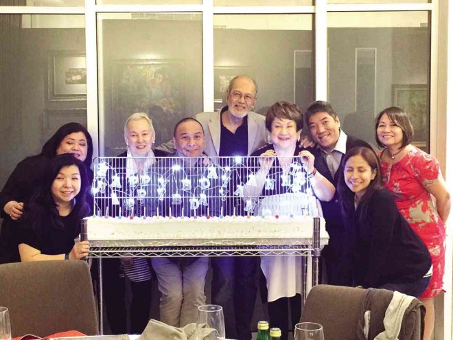 POSING behind the unique, long birthday cake for celebrators Annie Sarthou (third from left) and Ambeth Ocampo (second from right) are, from left, Sandy Tan-Uy, June Rufino, Dr.Nestor Pagulayan,National Artist BenCab, Virgie Ramos and Gina Garcia.