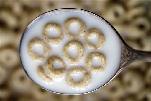 This June 15, 2011 file photo shows a spoonful of Honey Nut Cheerios in Pembroke, N.Y. General Mills on Monday, Oct. 5, 2015 said it is recalling 1.8 million boxes of Cheerios and Honey Nut Cheerios produced at a plant in Lodi, Calif., saying the cereal is labeled gluten-free but actually contains wheat. AP PHOTO