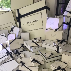 Jo Malone's iconic cream- colored gift boxes tied with black grosgrain ribbons