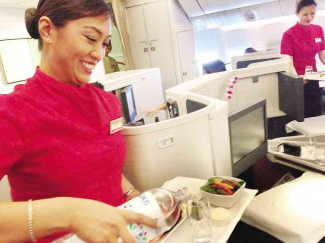 FILIPINA flight purser Menchie Aduan- Francisco gives service with a big smile.