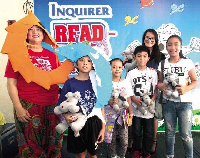 READ AND IMAGINE  In their shrimp and fish costumes, PDI president and CEO Sandy Prieto-Romualdez (left) and son Nico   lead a lively foray into the make-believe world  at the opening session of the 2-day Inquirer Read-Along Festival on Friday at CCP. Among those enjoying the fest are students from St. Alphonsus Liguori Integrated School and actress Ella Guevarra. 