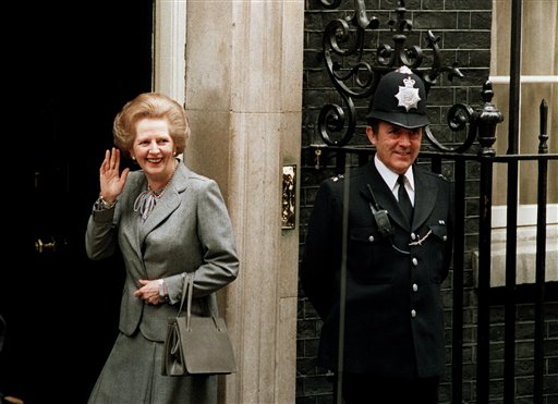 In this May 11, 1987 file photo, Britain's Prime Minister Margaret Thatcher waves to members of the media on returning to No. 10 Downing Street from Buckingham Palace after a visit with Queen Elizabeth II. Christies is set to sell personal possessions of late British Prime Minister Margaret Thatcher, including papers, mementoes, clothes _ and her iconic handbags. AP