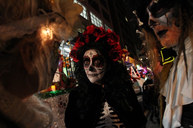 Sharon Hagale, center, waits with others for the start of the Greenwich Village Halloween Parade, Saturday Oct. 31, 2015, in New York.  (AP Photo/Tina Fineberg)