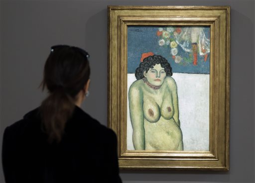 This file photo shows "The Nightclub Singer, a 1901 painting by Picasso from his Blue Period, at Sotheby's in New York. The work features a second picture on the reverse side depicting Picasso's art dealer, Pere Manach. The piece is estimated to fetch $60 million on Thursday night, Nov. 5, 2015 at Sotheby's fall art auction. AP FILE PHOTO