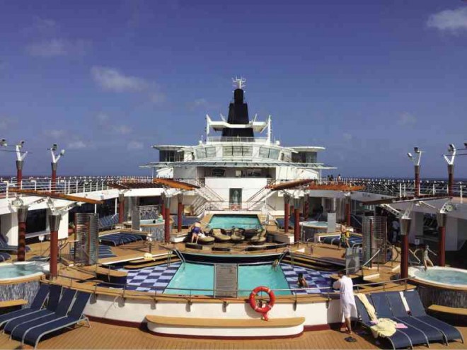 OUTDOOR pool area at the top deck of the ship