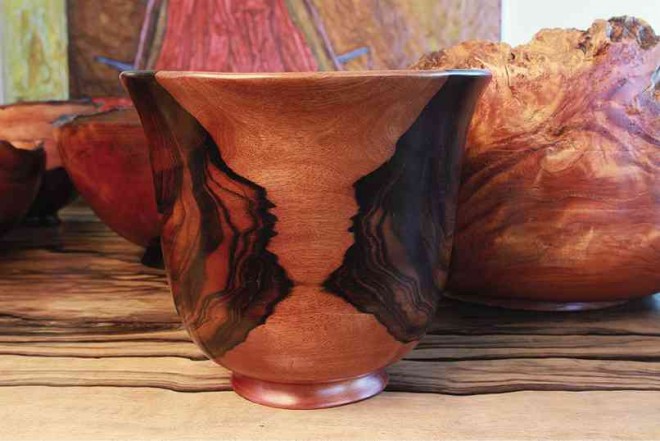ESGUERRA’S favorite piece: Dark areas that suggest two profiles talking to each other on an ironwood vase PHOTOS BY NELSON MATAWARAN