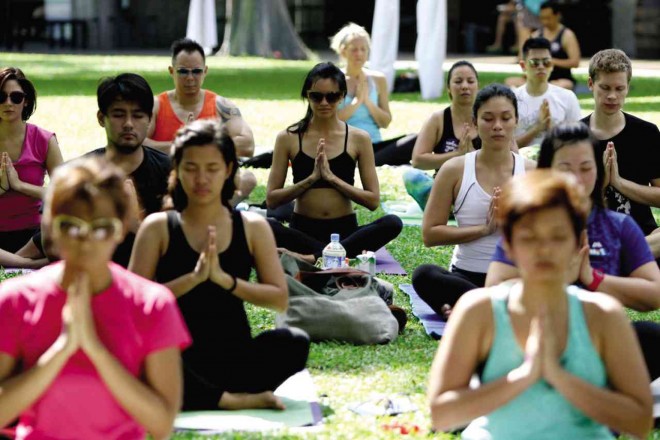 YOGIS woke up early on a Sunday to join the first Yoga in the Park at the Ayala Triangle Garden. PHOTOS BY RICHARD A. REYES