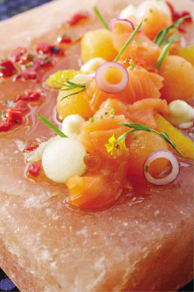 CITRUS-CURED Norwegian Salmon with compressed melons on a pink Himalayan salt block