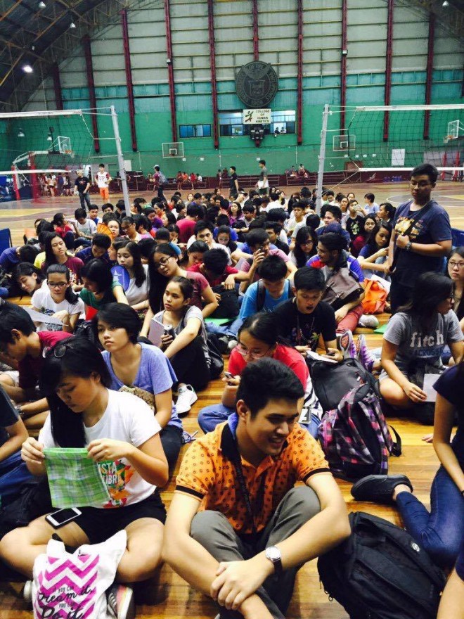 SEATED inside the UP gym, students from the College of Human Kinetics wait for their turn to enlist for classes. @JOAQLACSON