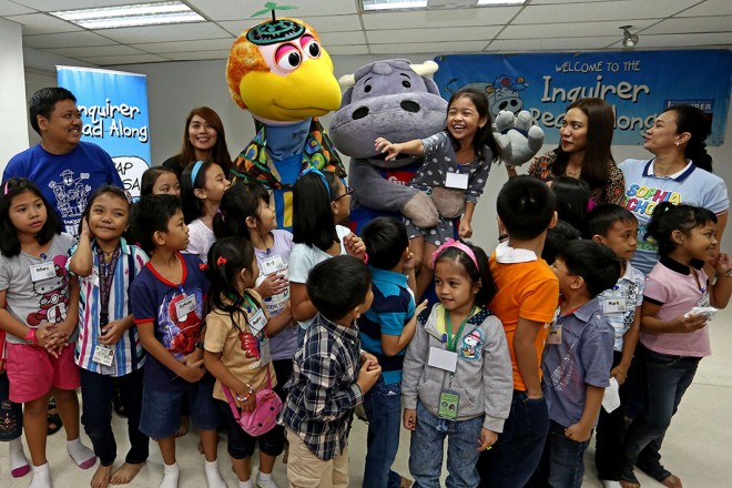 EDUCATION program head StephanieOrlino of Smart Communications, singer and actor Aicelle Santos, Sophia School principal Ann Abacan and the children pose with Koko Kwik-Kwak and Guyito at the Read-Along session Saturday. KIMBERLY DELA CRUZ