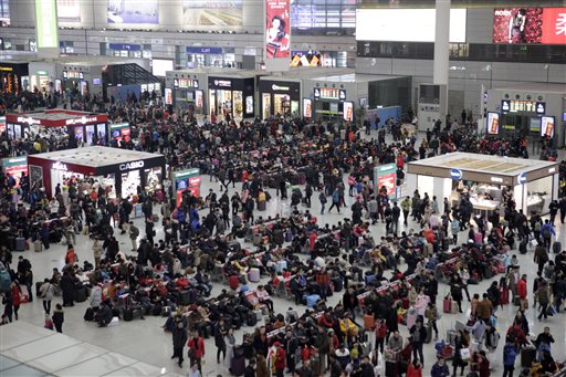 People sit in waiting areas at the Shanghai Hongqiao Railway Station in Shanghai, Friday, Jan. 29, 2016. Hundreds of thousands of passengers passed through Shanghai's railway stations on Friday in preparation for the upcoming Chinese New Year holiday, and according to state media, an estimated 2.91 billion journeys are expected to be made this year during the holiday period, traditionally a time for China's citizens to travel home and be with family and friends. AP Photo