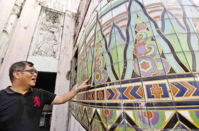 PROJECT architect Gerard Lico examines one of the tile mosaics of the Met.