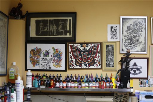 This Feb. 3, 2016 photo shows a shelf lined with bottles of tattoo ink, as well as artwork displayed on the wall of La Marca, or The Brand tattoo parlor in Havana, Cuba. Like so many other activities in Cuba, tattooing is neither illegal nor explicitly permitted and regulated, leaving it operating in a grey space Cubans refer to as alegal, meaning that it simply lacks any legal status, positive or negative. And like so many other goods, tattooing supplies cant be purchased, meaning ink, needles and other goods must be brought in via travelers luggage.   (AP Photo/Desmond Boylan)