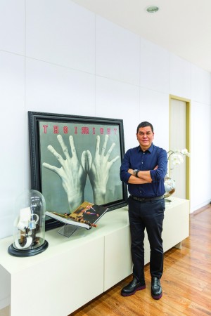Ben Chan, in his office, beside Ronald Ventura’s artwork of hands, a feng shui symbol of the ability to grasp the future and work hard PJ ENRIQUEZ 
