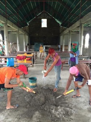 WORKERS mixing cement inside the chapel