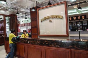 RECEPTION hall with glass panel from the original CBK Building on Quintin Paredes (Rosario) Street. The letters are gold- leafed. Background is the old Chinese-character signboard, also from the original office.