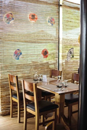 WOODEN blinds and tables lend a warm touch to the industrial finish of rough cement walls in Aozora.