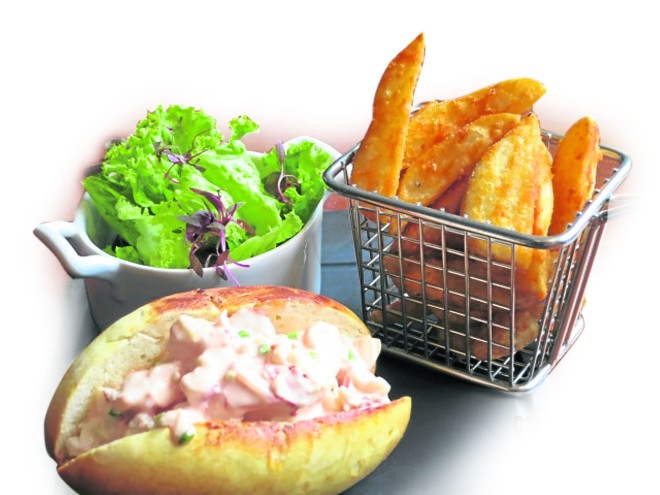 LOBSTER roll on toasted bun, potato wedges and salad 