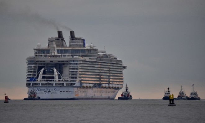 This file photo taken on March 10, 2016 shows the Harmony of the Seas cruise ship leaving the STX shipyard of Saint-Nazaire, western France, for a three-day offshore test.  STX France will deliver on May 12, 2016 in Saint-Nazaire the Harmony of the Seas, the largest cruise ship ever built, to US owner Royal Caribbean Cruises Ltd (RCCL). / AFP 