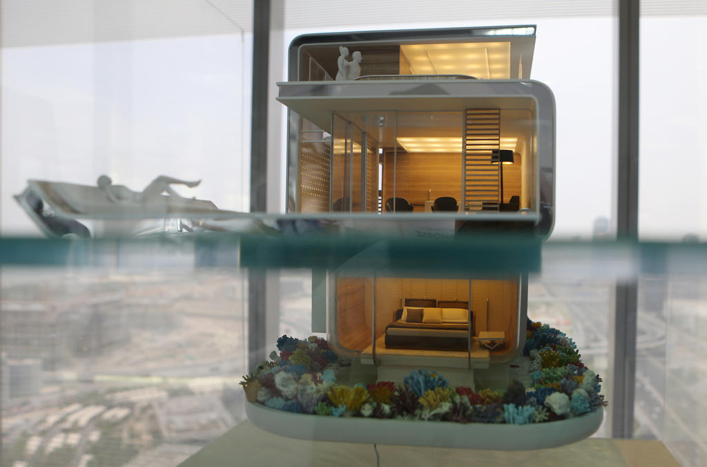 In this Monday, May 9, 2016 photo, the architectural model of the Floating Seahorse home is seen at the Kleindienst Group office in Dubai, United Arab Emirates. The Seahorses, part of an ambitious larger hotel development called The Heart of Europe, seeks to attract something that sounds even more grandiose. That's saving The World, as the long-stalled Earth-shaped island project off Dubai's coast is called. (AP Photo/Kamran Jebreili)