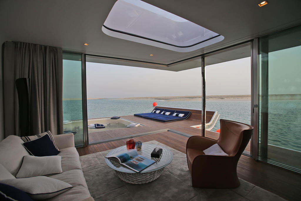 In this Monday, May 9, 2016 photo, the view of the sitting area of a full-scale mock-up of the Floating Seahorse home is seen on the waters of The Dubai World. The Seahorses, part of an ambitious larger hotel development called The Heart of Europe, seeks to attract something that sounds even more grandiose. That's saving The World, as the long-stalled Earth-shaped island project off Dubai's coast is called. (AP Photo/Kamran Jebreili)