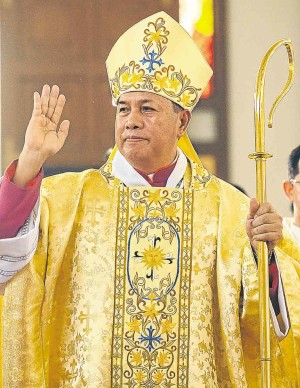 TARLAC Bishop elect Enrique V. Macaraeg waves to the faithful after his ordination in Dagupan City.