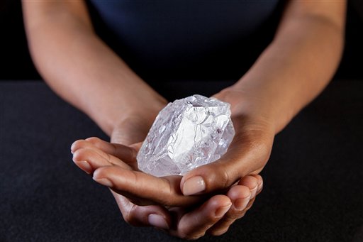 A Sotherby's employee holds Lesedi La Rona Diamond on May 3, 2016, in New York City. The diamond the size of a tennis ball that is the largest discovered in more than a century could sell at auction for more than $70 million. AP