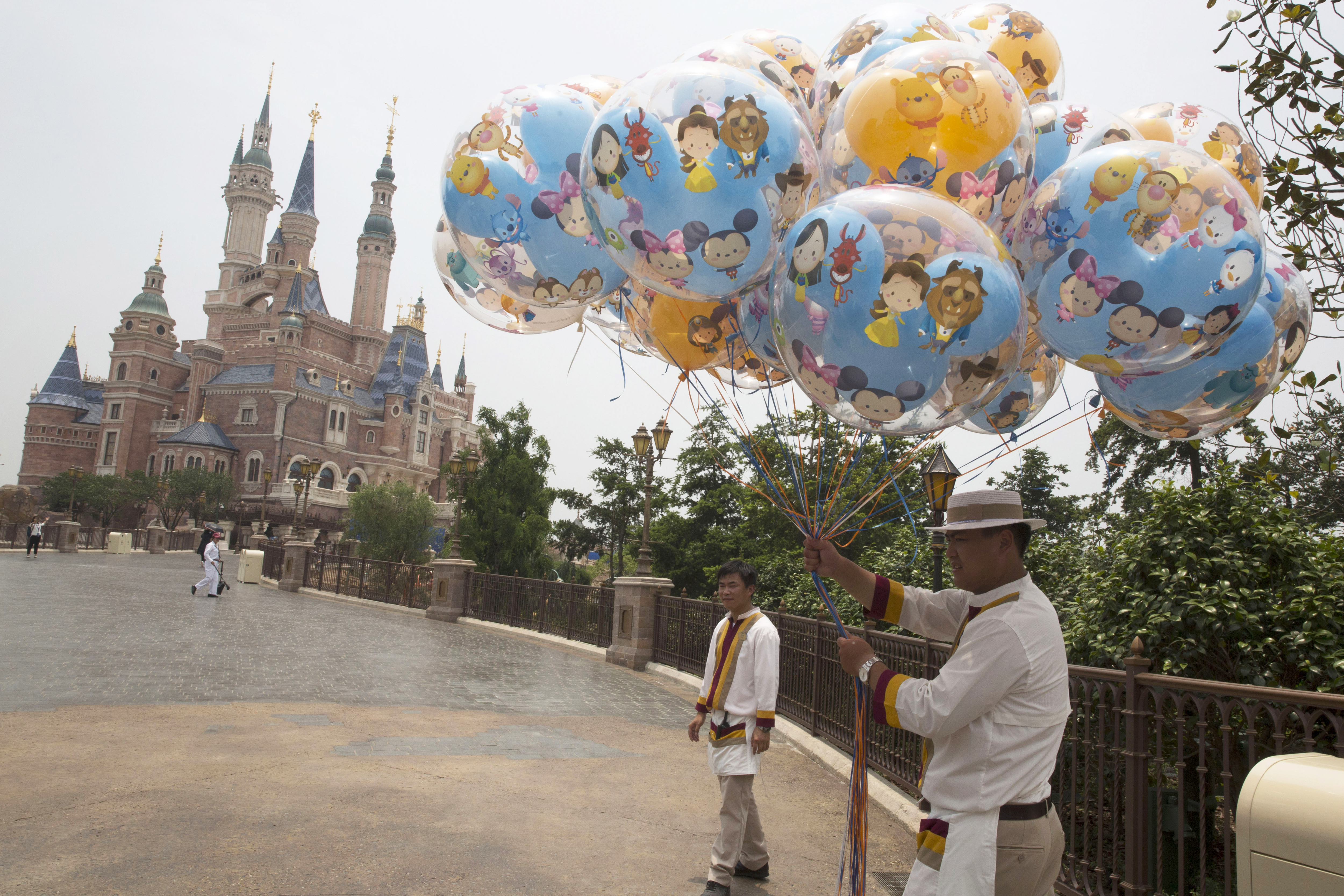Workers prepare during the eve of the opening of the Disney Resort in Shanghai, China, Wednesday, June 15, 2016. Disney will open its first resort in mainland China on Thursday. (AP Photo/Ng Han Guan)