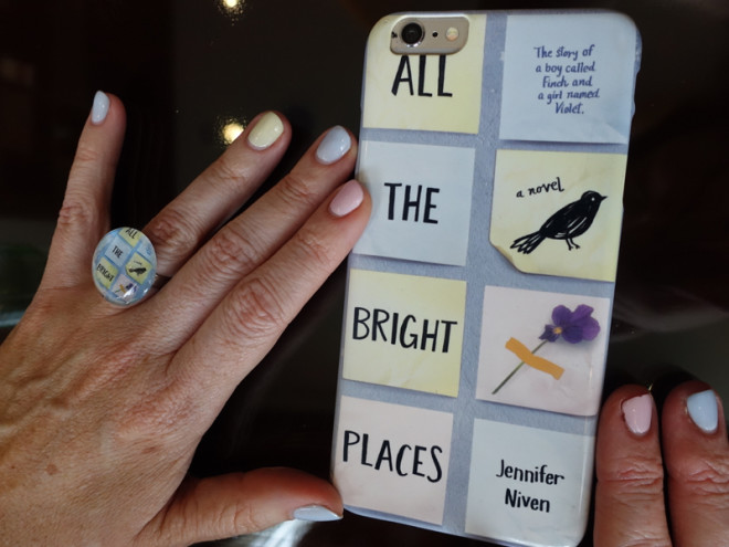 ALL THE bright merch. Jennifer’s matching book cover mani, ring and phone case