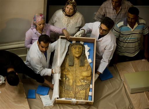 Egyptian antiquities officials uncrate a sarcophagus cover on its arrival to the Egyptian Museum in Cairo, Egypt, Tuesday, June 21, 2016. AP