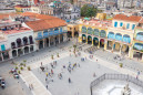 groups of tourists visit the old square in havana