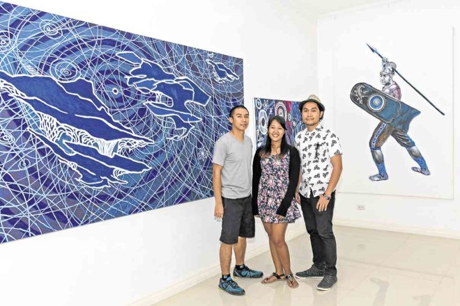 LIBY Norman Limoso, Allun May Gansa and Kris Brasileño, president of Iloilo Visual Artists Collective, pose in front of Limoso’s abstraction of the MiddleWorld and a hero from “Hinilawod.” PHOTOS BY PJ ENRIQUEZ