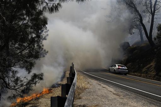 A wildfire burns on the hillside of Lake Isabella, Calif., Friday, June 24, 2016. The wildfire that roared across dry brush and trees in the mountains of central California gave residents little time to flee as flames burned homes to the ground, propane tanks exploded and smoke obscured the path to safety. AP 